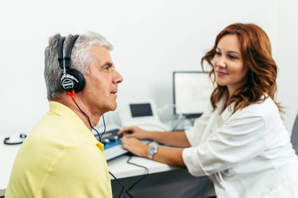 Hearing care professional listening to a patient